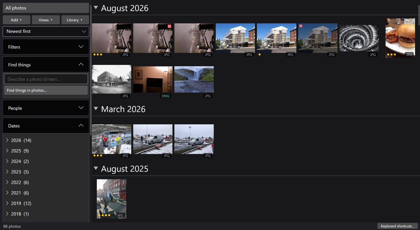 FastLoupe's photo grid at its densest zoom, with month headings and library controls on the left.
