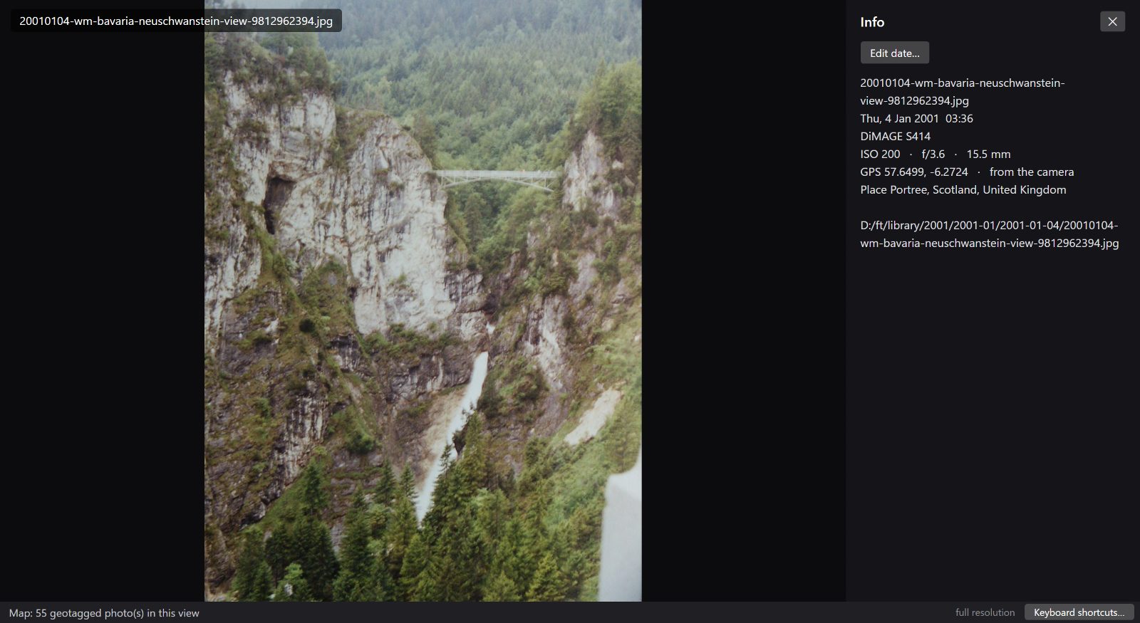 The loupe's info panel showing a photograph's coordinates and the name of the place.